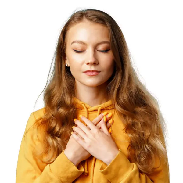 Portrait of a woman with eyes closed and hands over hear heart,