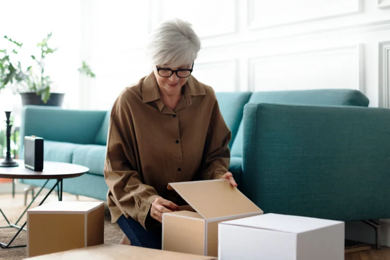 Woman unpacking brownboxes in the livingroom