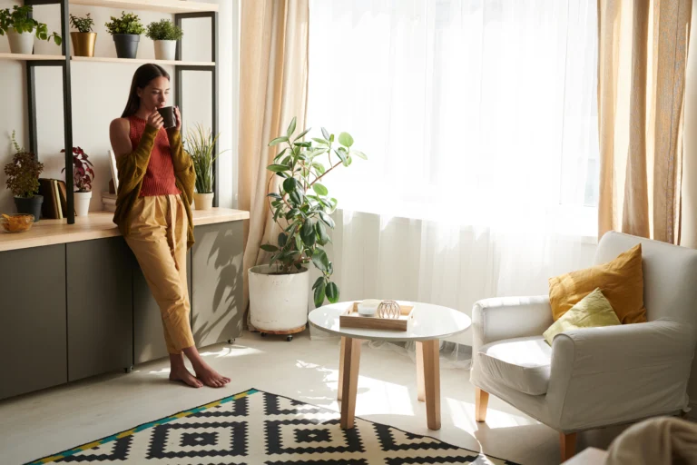 Young woman drinking tea in living room