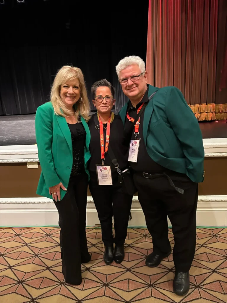 Three team members posing together at a business event in Austin