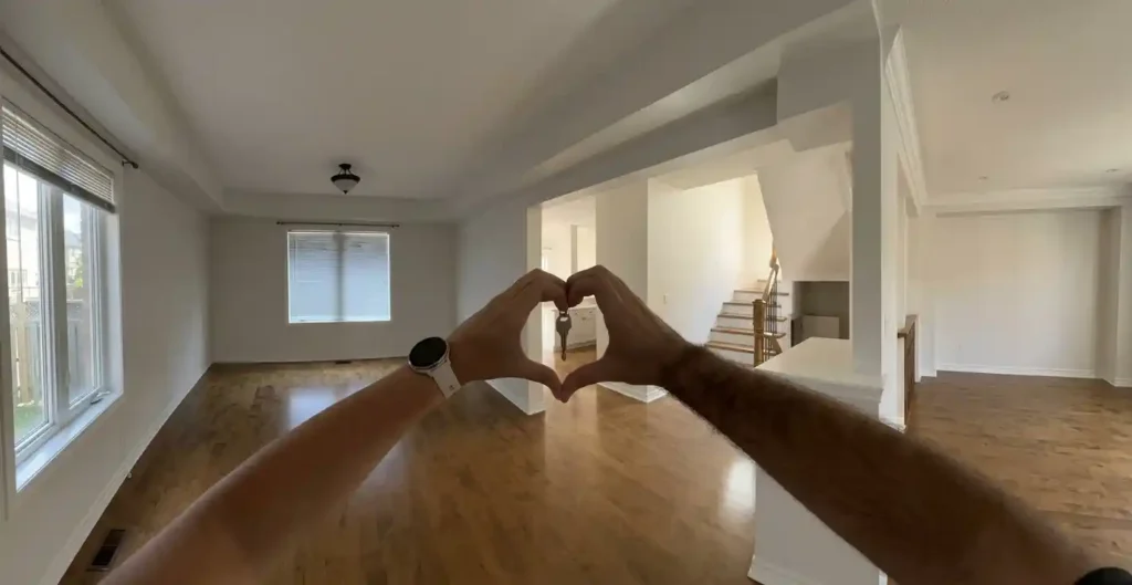 Hands forming a heart around house keys in a clean empty home in Austin