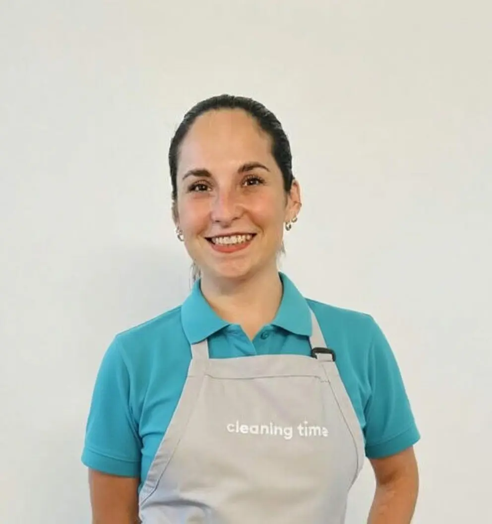 Professional house cleaner smiling in uniform for It’s Cleaning Time team in Austin