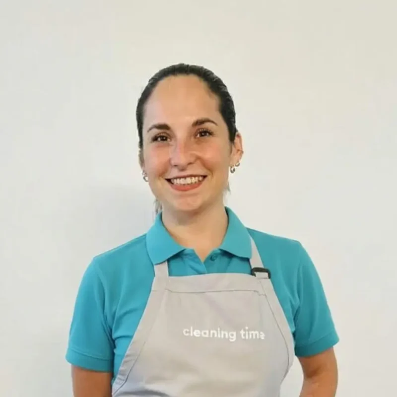 Professional house cleaner smiling in uniform for It’s Cleaning Time team in Austin