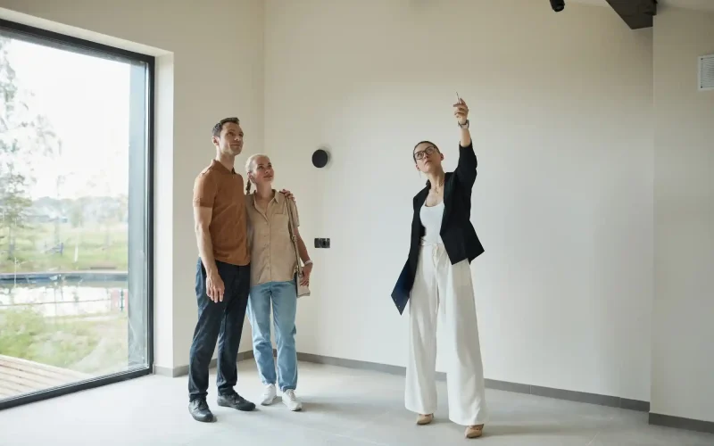 Real estate agent showing a clean empty home to a couple in Austin