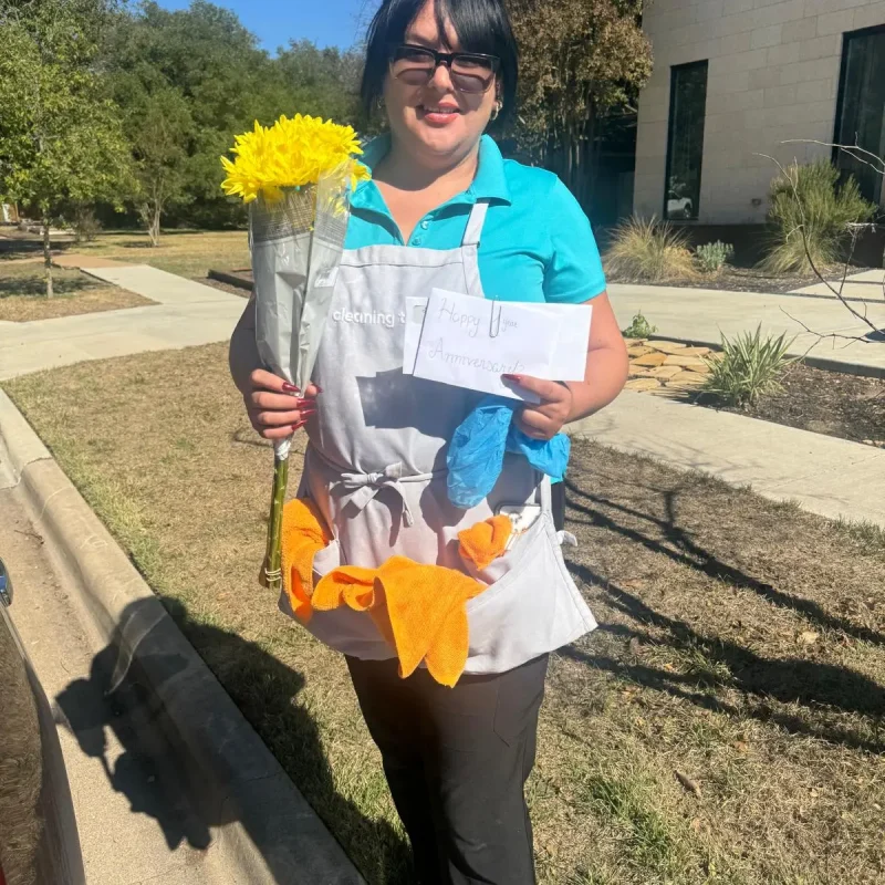 Team member holding flowers and supplies