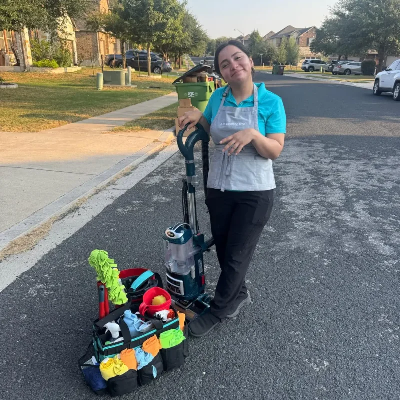 Team member with cleaning tools outdoors