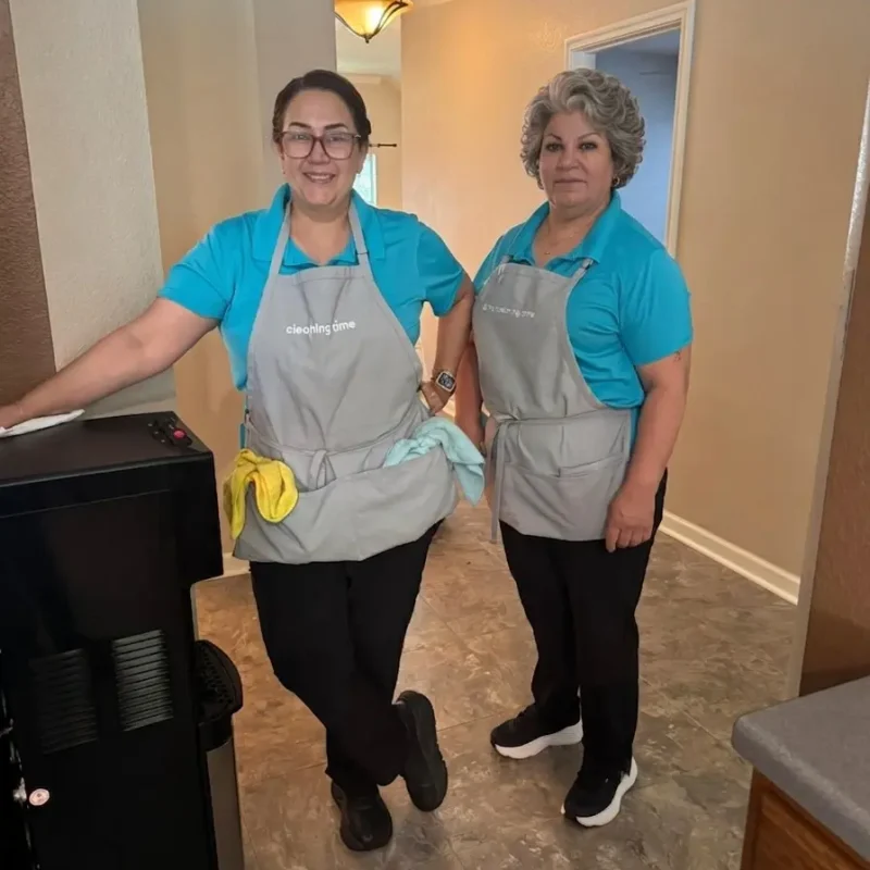 Two team members smiling in a home