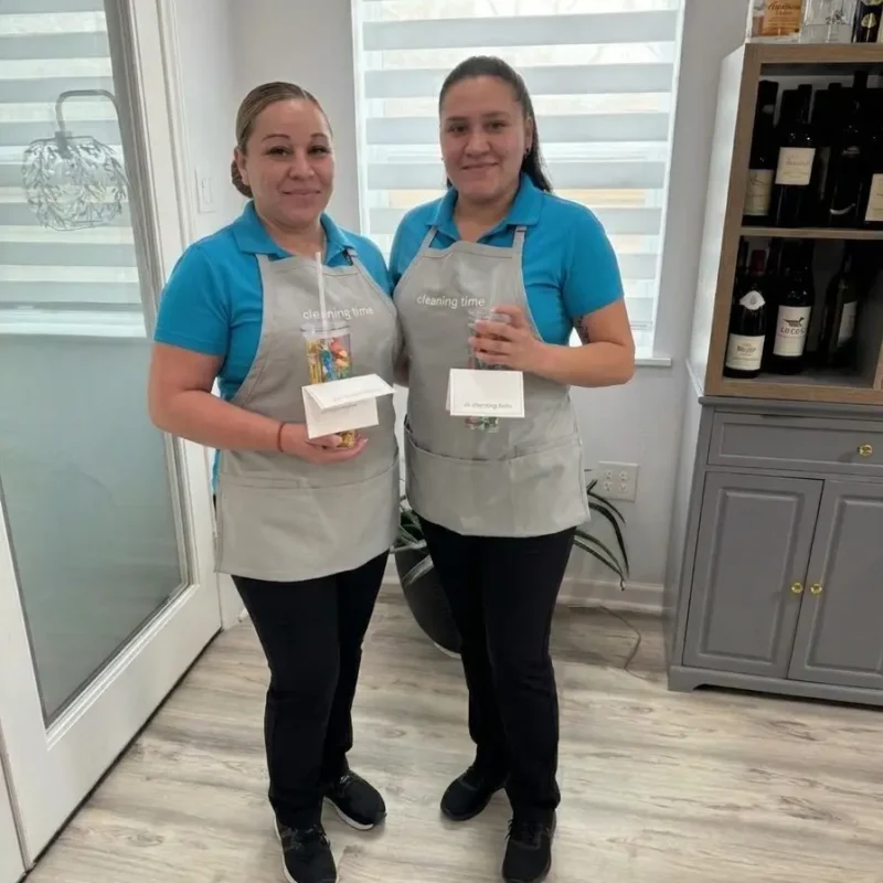 Two team members standing together indoors