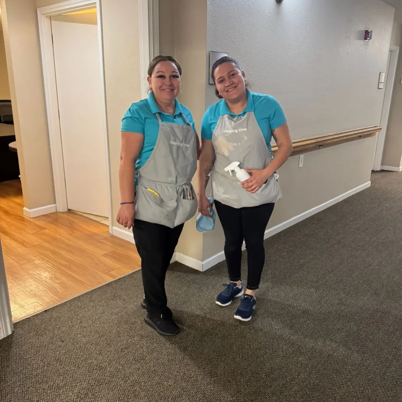 Two team members together in a hallway